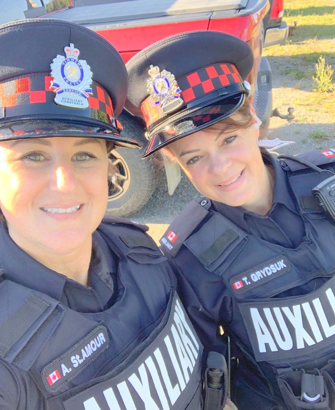 Two women from the Timmins Police posing for a photo in their uniforms.