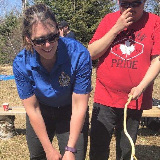 Timmins Police respond to a woman holding a snake while a man stands nearby.