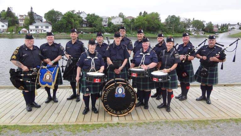The Timmins Police group of men in kilts posing for a photo.