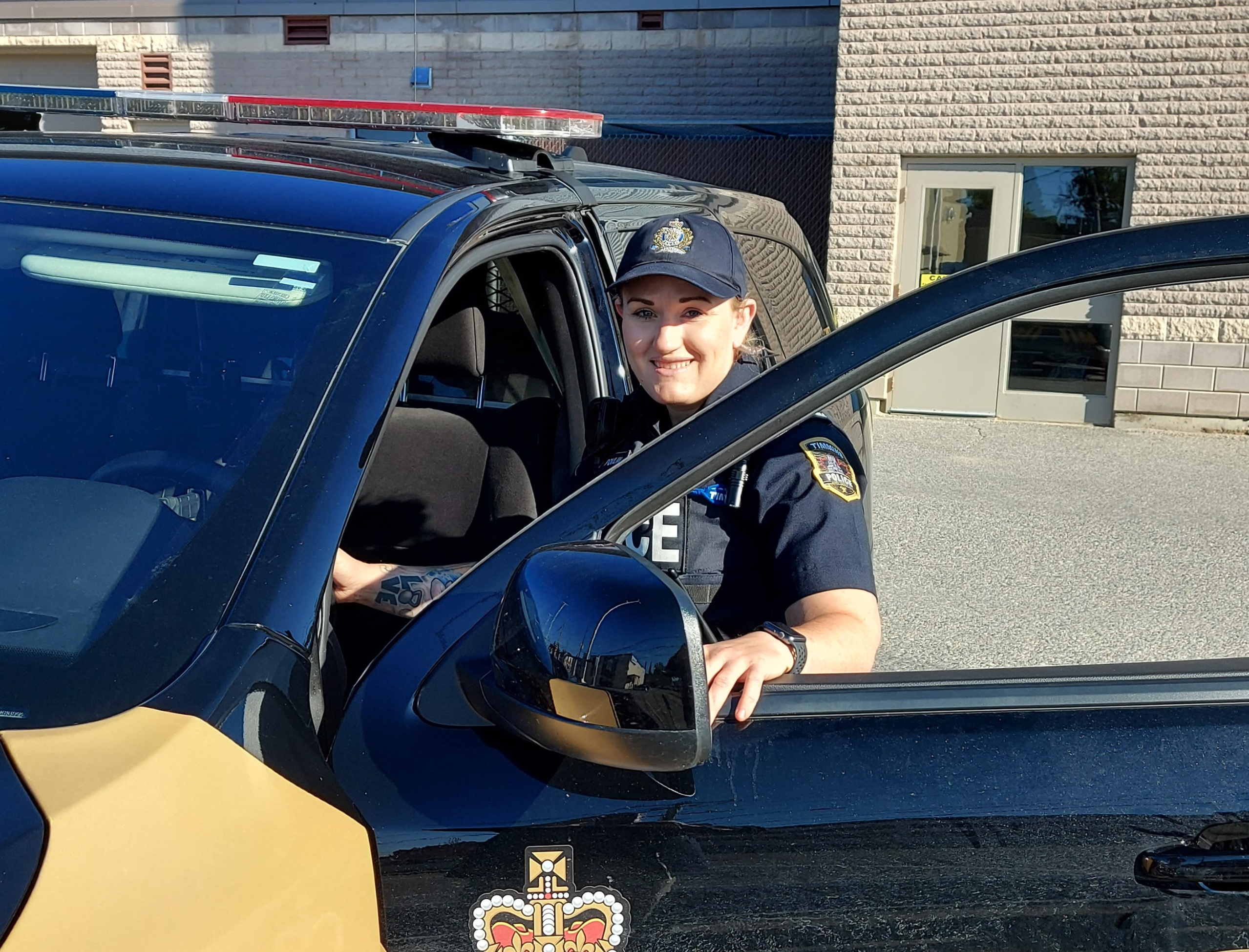 Timmins Police A Timmins police officer sitting in the driver's seat of a car.